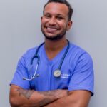 man in blue crew neck t-shirt smiling